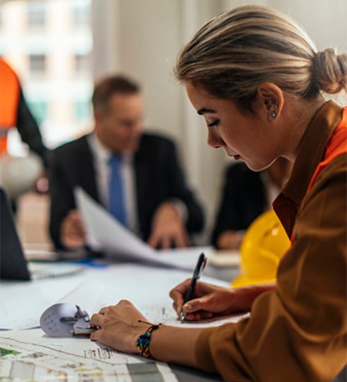 Woman writing notes in a meeting