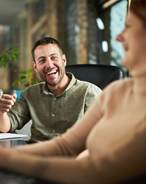 Man sharing a joke with a workmate